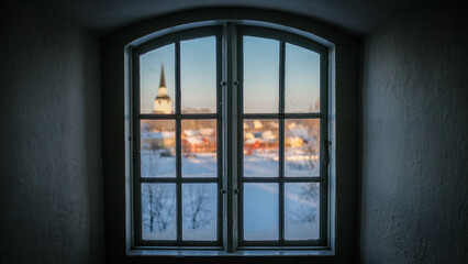 Fototapeta premium A small town is viewed through the window of a castle. 