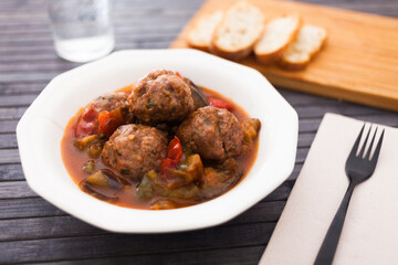 Cooked meatballs with stewed eggplant in bowl