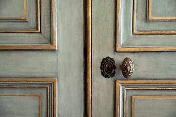 Detail of an old wooden door of blue-grey color