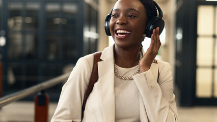 Smiling Businesswoman Listening to Music with Headphones in Modern Industrial Office
