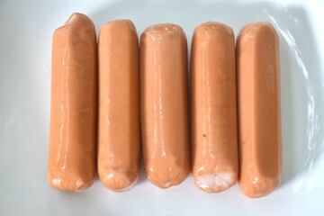 raw long smoked pork sausage arranging on plate 