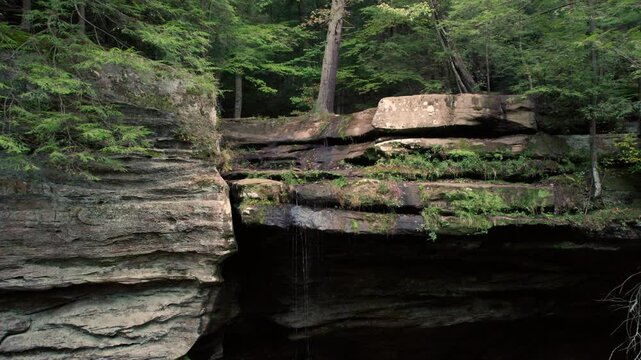 Fantasy Landscape Waterfall Hanging Cliffs Aerial. Hallelujah Mountains. Trees Growing Out of Rock. Hocking Hills Ash Cave Magical Aerial Tour Forest Hiking Trail Scenic View..