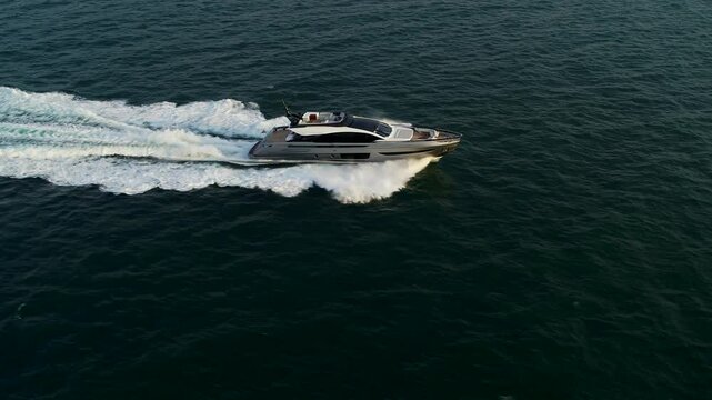 Aerial view of luxury yacht and motor boat at sunset, Dubai, United Arab Emirates.
