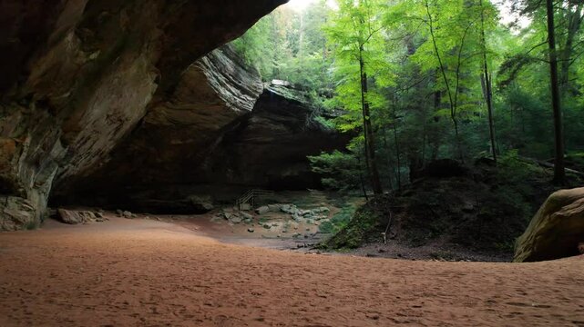 Hocking Hills Ash Cave Aerial Tour Lush Forest Hiking Trail Scenic View. Start Low to Sand and Drone Up to Waterfall Overhang.