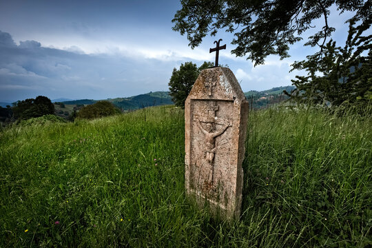 Velo Veronese: ancient folk sculpture of the crucifixion of Jesus Christ in the meadow of Contrada Riva. Azzarino, Lessinia, Veneto, Italy.