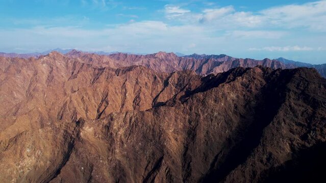 Aerial view of majestic mountains and valleys in Jebel Jais, Ras Al Khaimah, United Arab Emirates.
