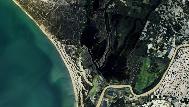 Aerial view of donana national park showing coastal changes and contrast between land and water. Based on image by Nasa