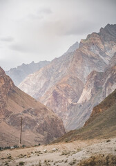 Obraz premium Rocky red, russet, orange and brown mountains and cliffs in the Pamirs in the mountains of Tajikistan