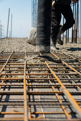 Iron grate or reinforcement on the ground poured with concrete at a construction site