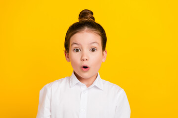 Portrait of cute schoolgirl open mouth empty space wear uniform isolated on yellow color background