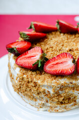 Crepe cake Medovik with sour cream vanilla cream and strawberries. Pancake cake Medovik decorated with strawberries.