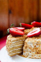 Crepe cake Medovik with sour cream vanilla cream and strawberries. Pancake cake Medovik decorated with strawberries.