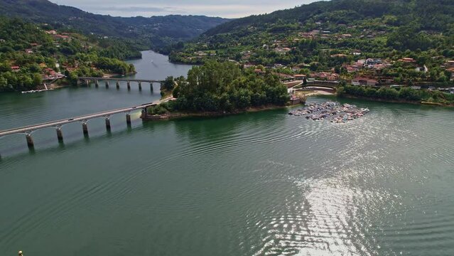 A beautiful Aerial view of a bridge over the Cavado River with reflections in Peneda-Geres National Park, Portugal