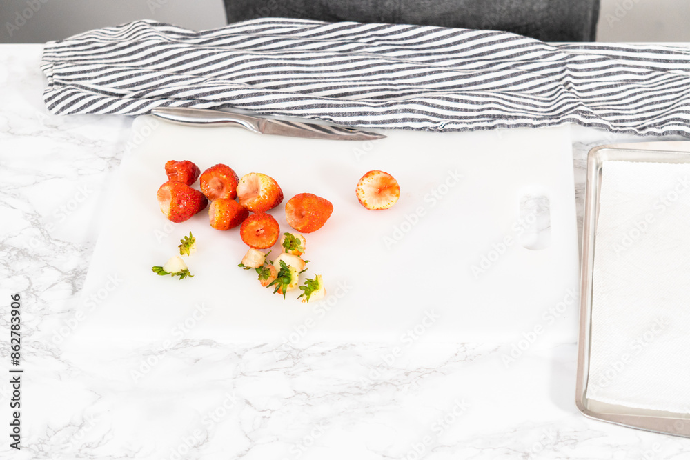 Wall mural cutting fresh strawberries on a white cutting board