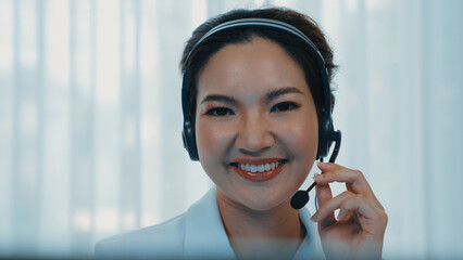 Businesswoman wearing vivancy headset working in office to support remote customer or colleague. Call center, telemarketing, customer support agent provide service on telephone video conference call