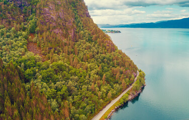 Fjord on a cloudy day. Rocky coast in the evening. Beautiful nature of Norway. Picturesque Scandinavian landscape. Norway, Europe