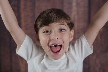Happy little boy with the two front teeth missing 