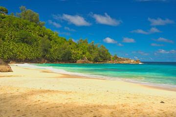 Anse Intendance beach, blue sky turquoise water, low tide with waves, sunny day, white sandy beach, Mahe, Seychelles