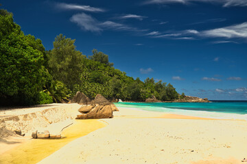 Anse Intendance beach, blue sky turquoise water, low tide with waves, sunny day, white sandy beach, Mahe, Seychelles