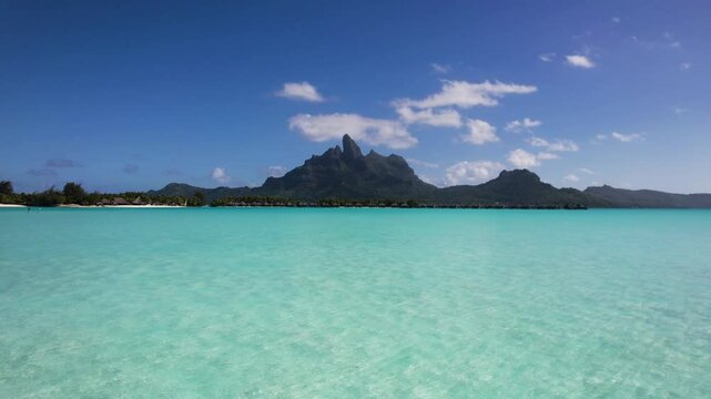 Aerial view of turquoise water and overwater bungalows at The St Regis Bora Bora Resort, Mount Otemanu, Bora Bora Lagoon, French Polynesia.