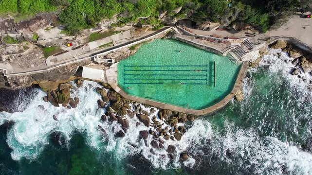 Aerial view of Bronte Baths with swimmers, Bronte Beach, Sydney, Australia.