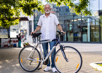 Fototapeta premium Portrait, business and mature man with bike, travel and confident with background, startup and eco friendly. Person, entrepreneur and employee with bicycle, transportation and sustainability.