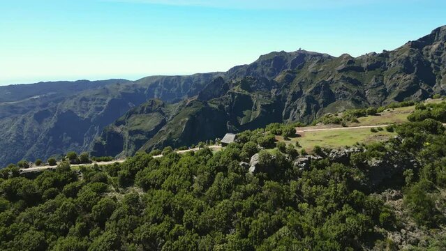 Aerial view of lush greenery and rocky terrain along Vereda do Pico Ruivo, Madeira, Portugal.