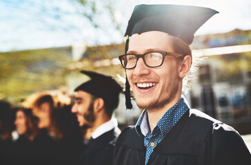 Man, portrait and smile for university graduation with glasses, happiness for degree or diploma...
