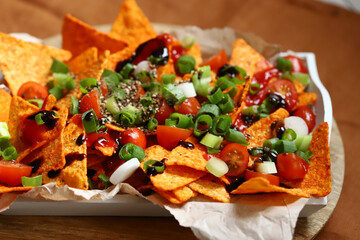 Nacho chips with green onions and spices.