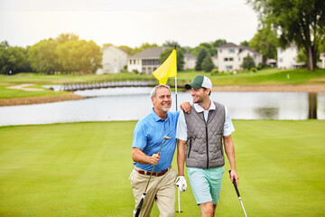 Men, golf course and fun on green for tee in outdoor as members in club for health, wellness or...