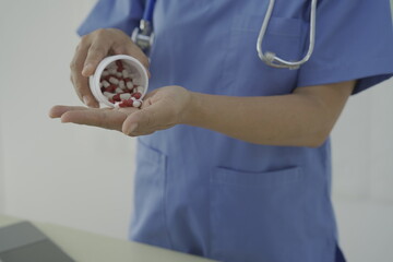 Pharmacist holds a prescription and tries to explain how to use the medicine to a patient. Pharmacy. Asian female health worker is explaining a prescription to a patient. Medicine Pharmacist.