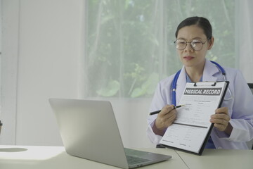 Pharmacist holds a prescription and tries to explain how to use the medicine to a patient. Pharmacy. Asian female health worker is explaining a prescription to a patient. Medicine Pharmacist.