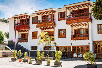 Fototapeta premium A building with traditional wooden balconies and window frames, located in Los Gigantes, Tenerife