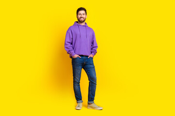 Fototapeta premium Full size photo of handsome young guy confident posing wear trendy violet outfit isolated on yellow color background