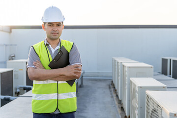 Portrait Asian maintenance engineer works on the roof of factory. contractor inspect compressor...