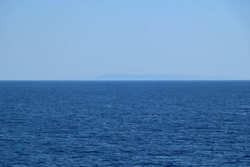 Fototapeta premium blue sky and sea - island at horizon - Agios Efstratios, Greece, aegean sea