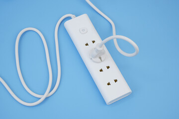 Electric sockets with connected plug on blue background. 