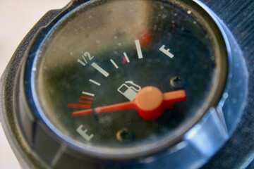 Motorcycle fuel gauge. The arrow on the fuel gauge shows an empty tank.