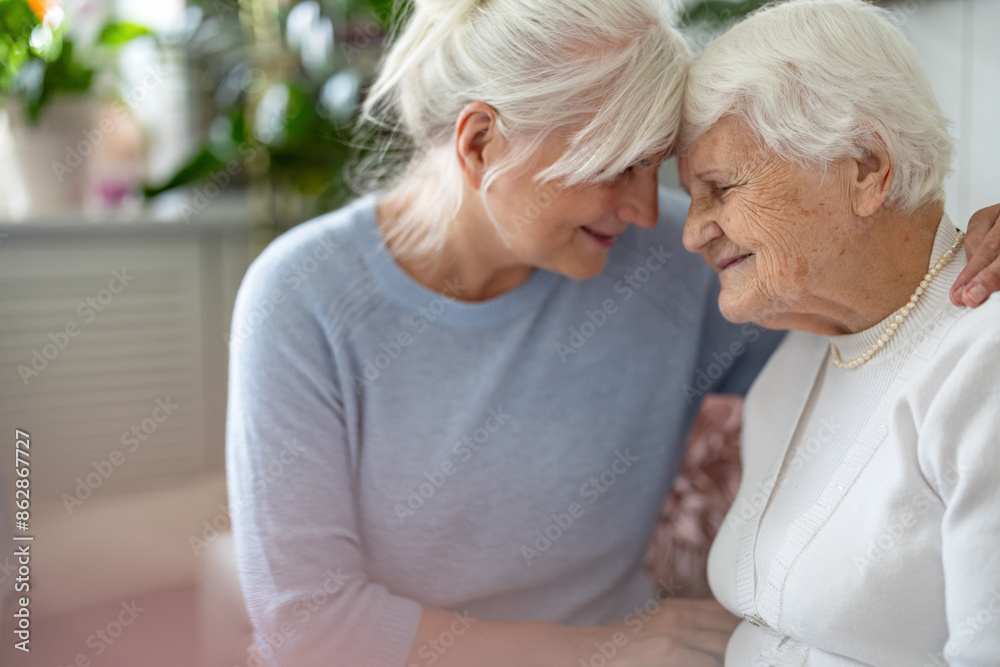 Sticker happy senior woman with her adult daughter at home