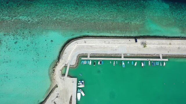 Aerial view of luxury island resort with turquoise ocean, Thoddoo Atoll, Maldives.