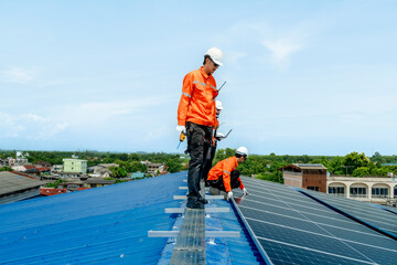 engineer man inspects construction of solar cell panel or photovoltaic cell by electronic device. Industrial Renewable energy of green power. factory worker working on tower roof.