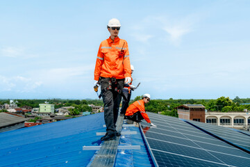 engineer man inspects construction of solar cell panel or photovoltaic cell by electronic device. Industrial Renewable energy of green power. factory worker working on tower roof.