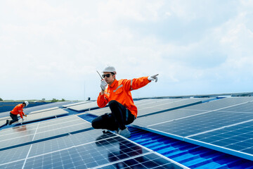 engineer man inspects construction of solar cell panel or photovoltaic cell by electronic device....