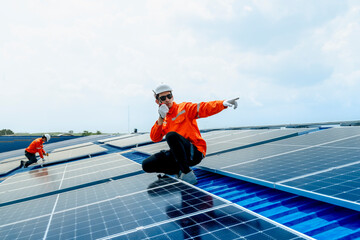 engineer man inspects construction of solar cell panel or photovoltaic cell by electronic device....