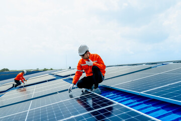 engineer man inspects construction of solar cell panel or photovoltaic cell by electronic device. Industrial Renewable energy of green power. factory worker working on tower roof.