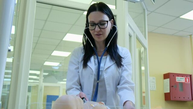 Child mannequin model for teaching medical practice. A mannequin for medical students studying at medical faculties. Teacher interacting with a mannequin
