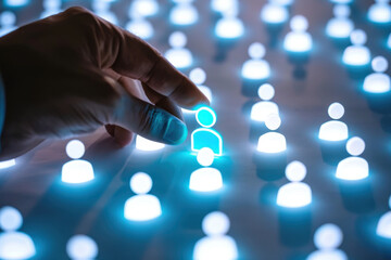 Hand choosing digital human icon, symbolizing connection, recruitment, and digital communication.