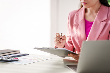 40-year-old middle-aged Asian businesswoman wearing pink suit, business finance, investment...
