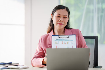 40-year-old middle-aged Asian businesswoman wearing pink suit, business finance, investment...