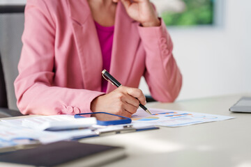 40-year-old middle-aged Asian businesswoman wearing pink suit, business finance, investment...